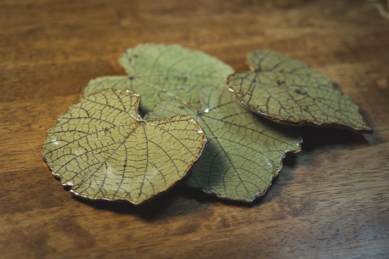 Three leaf-shaped plates with pressed vein detail, glazed in soft green.